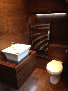 Installation of an en suite, finished project with towel rack, toilet and baisin
